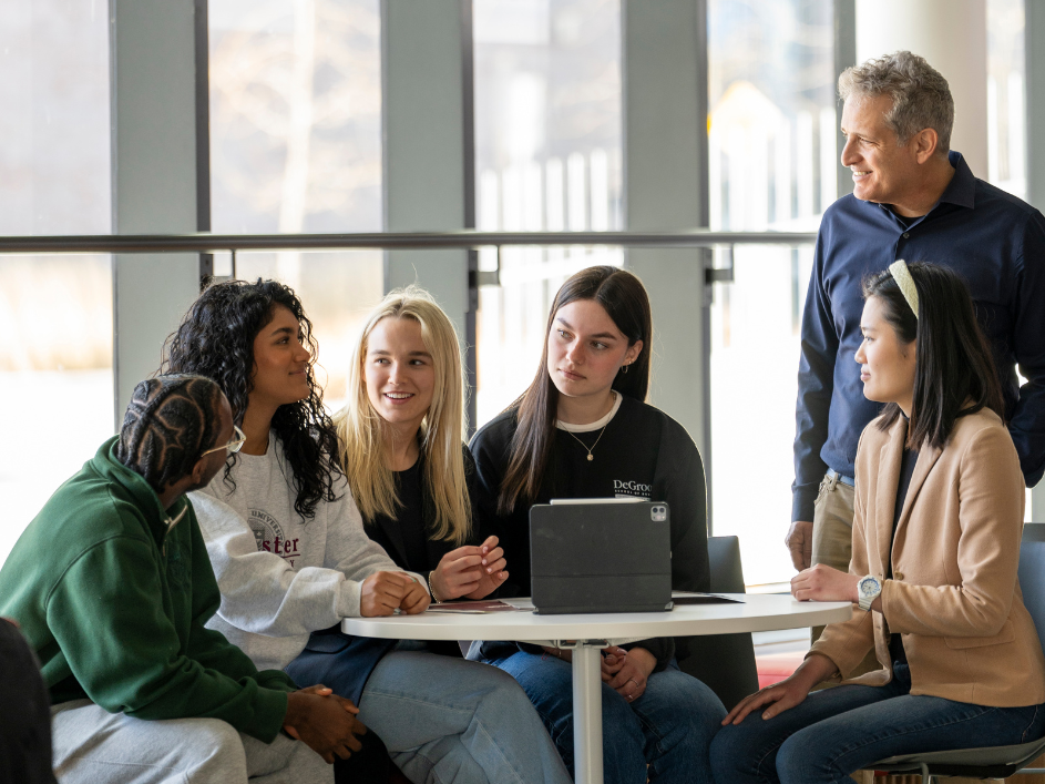 A professor guiding a student discussion.